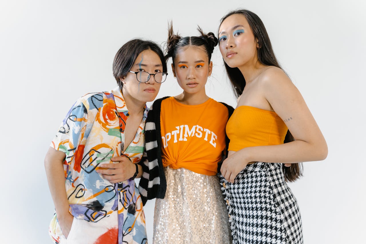 hero-img-01 Trendy group studio shoot showcasing vibrant fashion and makeup.